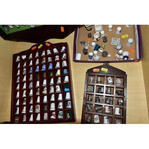 678 - THREE WOODEN DISPLAY SHELVES OF METAL AND CERAMIC THIMBLES AND SOUVENIR SPOONS, together with a smal... 