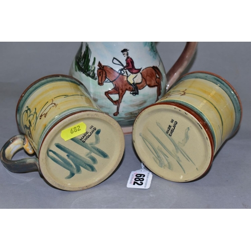 682 - A PAIR OF GLYN COLLEDGE OF DENBY HAND PAINTED HUNTING MUGS AND A BALUSTER SHAPED TANKARD, similarly ... 