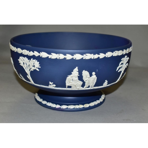 696 - A WEDGWOOD DARK BLUE JASPERWARE PEDESTAL FRUIT BOWL, the applied decoration of classical figures in ... 