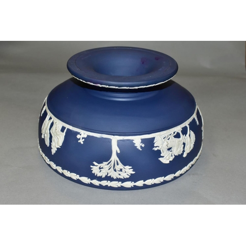 696 - A WEDGWOOD DARK BLUE JASPERWARE PEDESTAL FRUIT BOWL, the applied decoration of classical figures in ... 