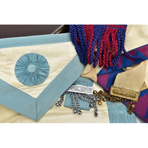 76 - TWO CASES OF MASONIC REGALIA, to include Masonic aprons, one with a blue, purple and white design th... 