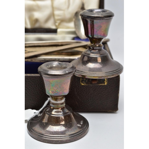 90 - A CASED SILVER VANITY SET WITH TWO CANDLE STICKS AND A TEASPOON, the brown case opens to reveal a th... 