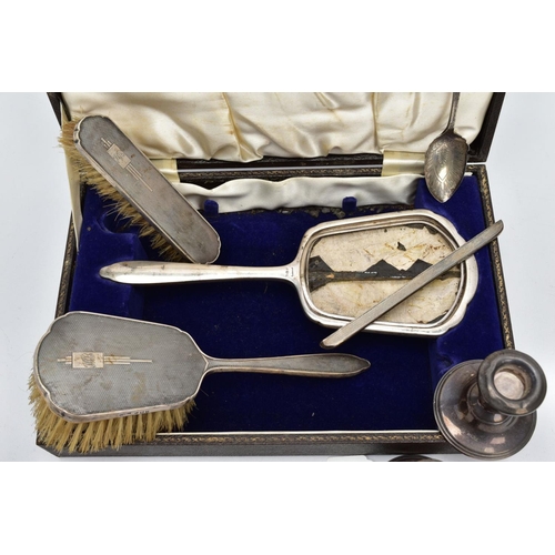 90 - A CASED SILVER VANITY SET WITH TWO CANDLE STICKS AND A TEASPOON, the brown case opens to reveal a th... 