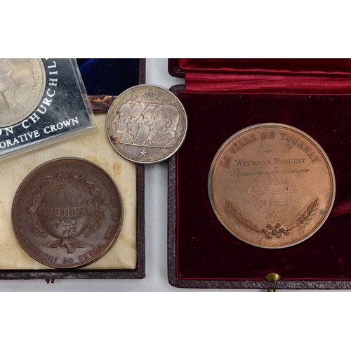 123 - A SMALL PLASTIC BOX OF MEDALS AND COMMEMORATIVES, to include three white metal medals to Norbet Weth... 