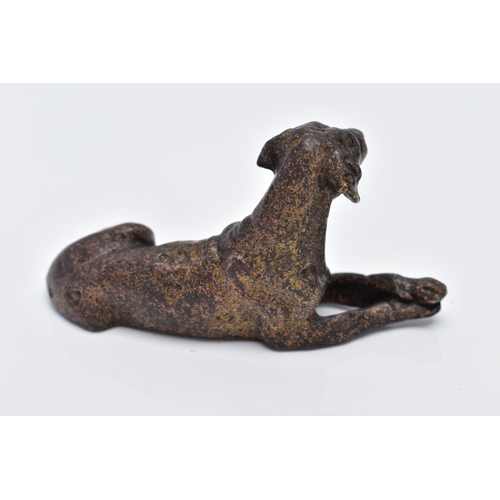 13 - A SMALL BRONZED DOG, in a lying down position, approximate length 70.4mm