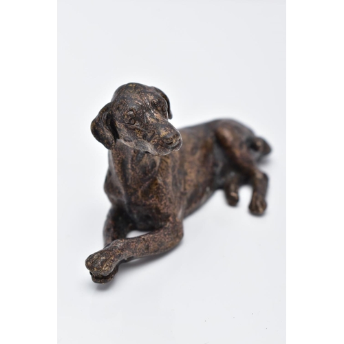 13 - A SMALL BRONZED DOG, in a lying down position, approximate length 70.4mm