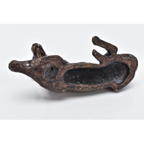 13 - A SMALL BRONZED DOG, in a lying down position, approximate length 70.4mm