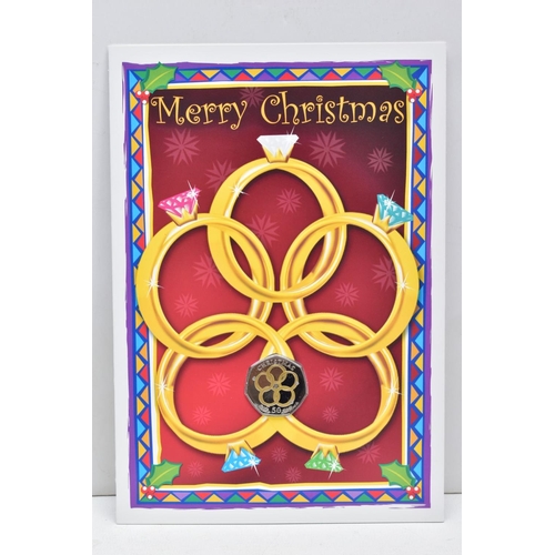 149 - CHRISTMAS COLOURED FIVE GOLDEN RINGS FIFTY PENCE, Isle of Man coin Pobjoy mounted on card in 2009, a... 