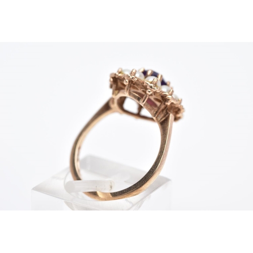 21 - A 9CT GOLD AMETHYST AND SPLIT PEARL CLUSTER RING, the raised cluster designed with a central oval cu... 