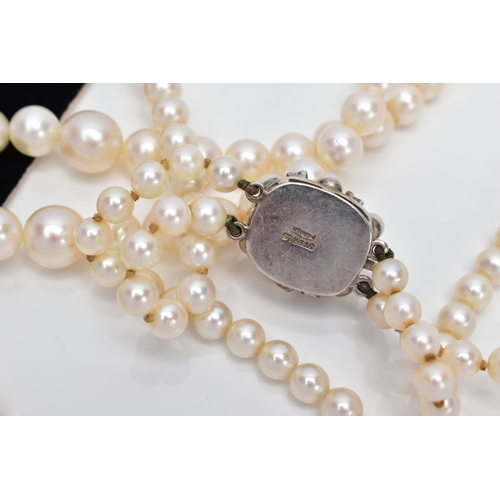 24 - A CULTURED PEARL NECKLACE, designed with two strands of graduated cultured pearls, measuring approxi... 