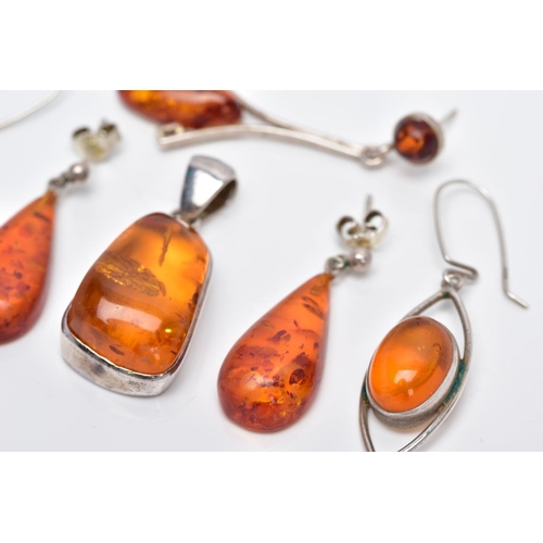 39 - A COLLECTION OF MODERN AMBER JEWELLERY, to include an abstract shaped pendant, two pairs of drop ear... 