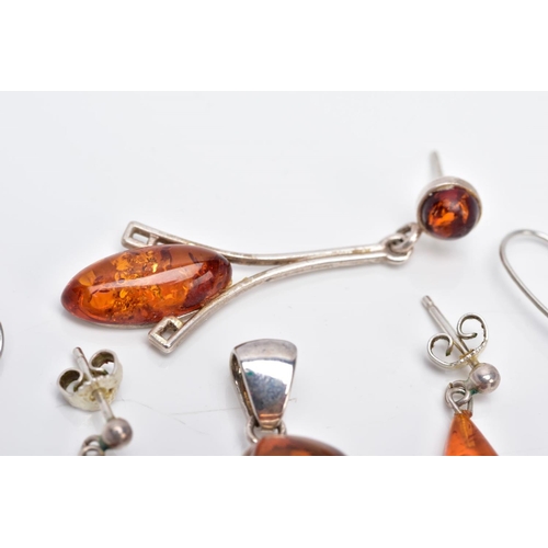 39 - A COLLECTION OF MODERN AMBER JEWELLERY, to include an abstract shaped pendant, two pairs of drop ear... 