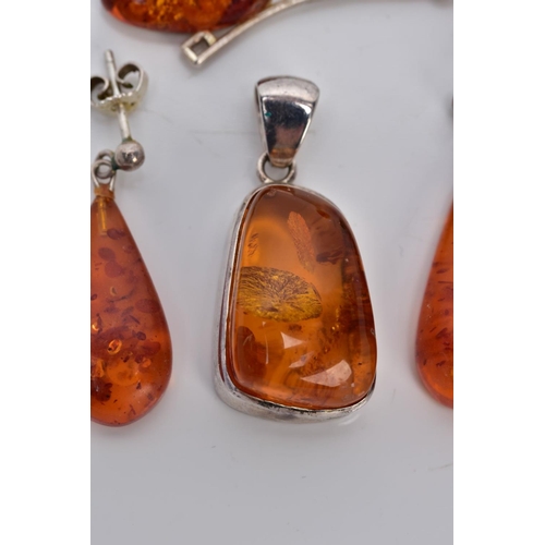 39 - A COLLECTION OF MODERN AMBER JEWELLERY, to include an abstract shaped pendant, two pairs of drop ear... 