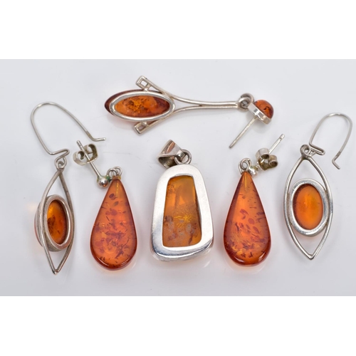 39 - A COLLECTION OF MODERN AMBER JEWELLERY, to include an abstract shaped pendant, two pairs of drop ear... 