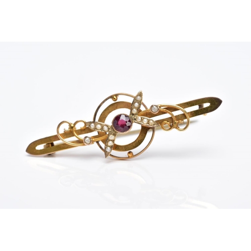 47 - AN EARLY 20TH CENTURY GARNET AND SPLIT PEARL BAR BROOCH with scroll and foliate detail, stamped '9c'... 