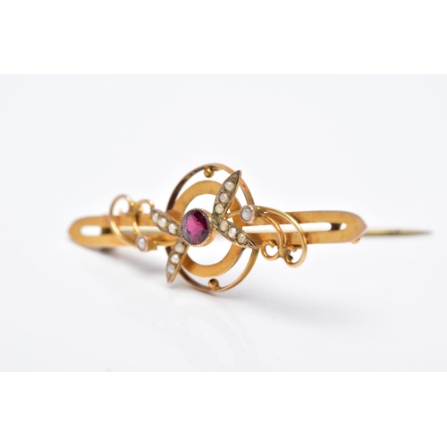 47 - AN EARLY 20TH CENTURY GARNET AND SPLIT PEARL BAR BROOCH with scroll and foliate detail, stamped '9c'... 