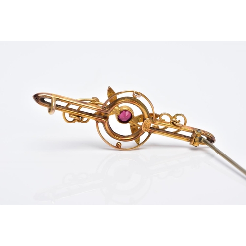 47 - AN EARLY 20TH CENTURY GARNET AND SPLIT PEARL BAR BROOCH with scroll and foliate detail, stamped '9c'... 