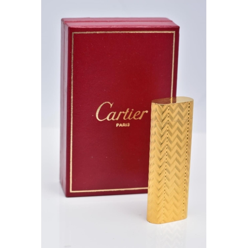 49 - A CARTIER GOLD PLATED LIGHTER, oval rectangular form with engine turned engraving decoration, signed... 