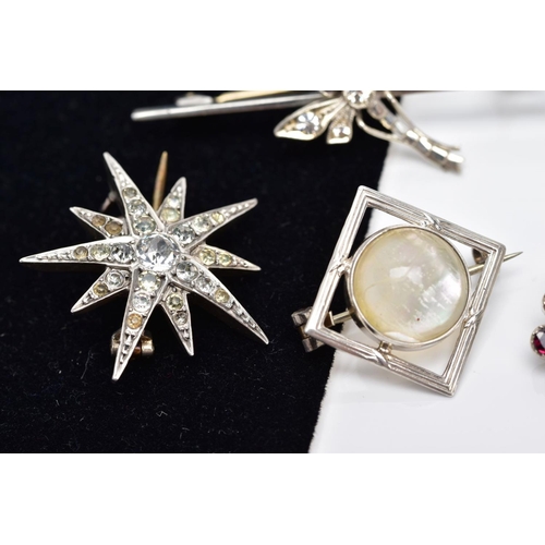 50 - A COLLECTION OF SIX ASSORTED WHITE METAL BROOCHES, to include an early 20th century paste set swallo... 