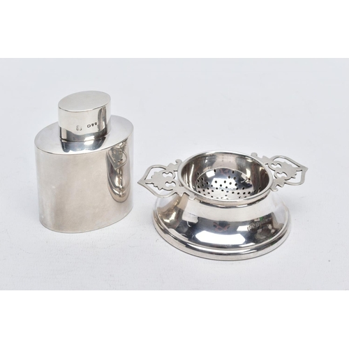 64 - A SILVER TEA STRAINER AND TEA CADDY, the tea strainer with double openwork handles hallmarked Birmin... 