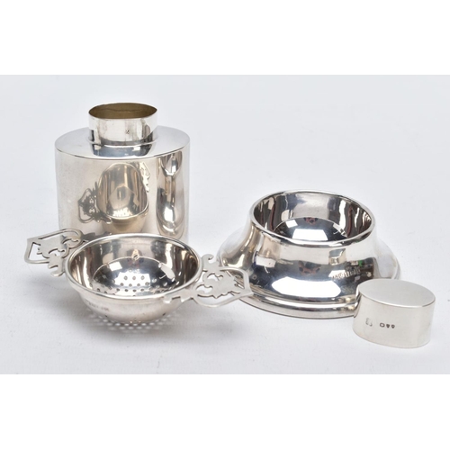 64 - A SILVER TEA STRAINER AND TEA CADDY, the tea strainer with double openwork handles hallmarked Birmin... 