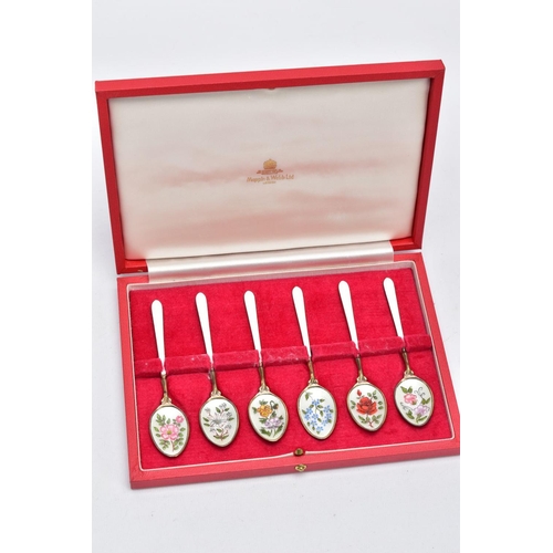 67 - A CASED SET OF SIX SILVER ENAMELLED COFFEE SPOONS, each silver gilt spoon has a decorative floral en... 