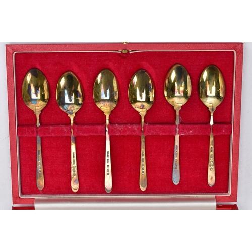 67 - A CASED SET OF SIX SILVER ENAMELLED COFFEE SPOONS, each silver gilt spoon has a decorative floral en... 