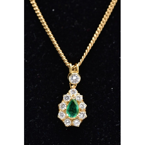 83 - AN EMERALD AND DIAMOND PENDANT NECKLET, the yellow metal tear drop pendant set with a central pear c... 