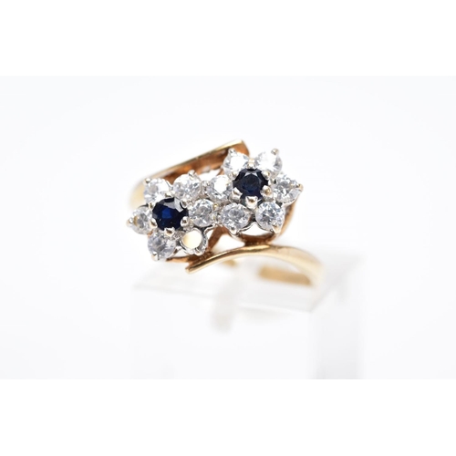 84 - A 9CT GOLD SAPPHIRE AND CUBIC ZIRCONIA DOUBLE CLUSTER RING, designed with two asymmetrical clusters,... 