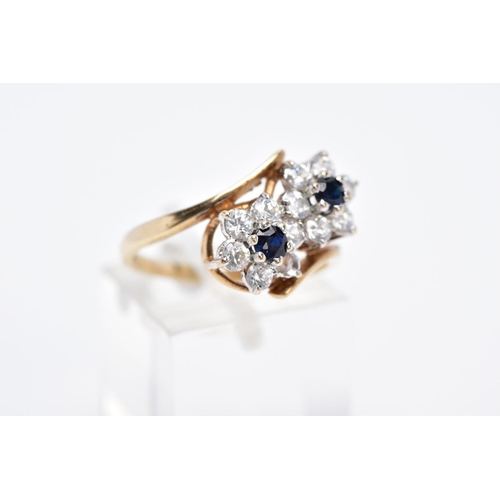 84 - A 9CT GOLD SAPPHIRE AND CUBIC ZIRCONIA DOUBLE CLUSTER RING, designed with two asymmetrical clusters,... 