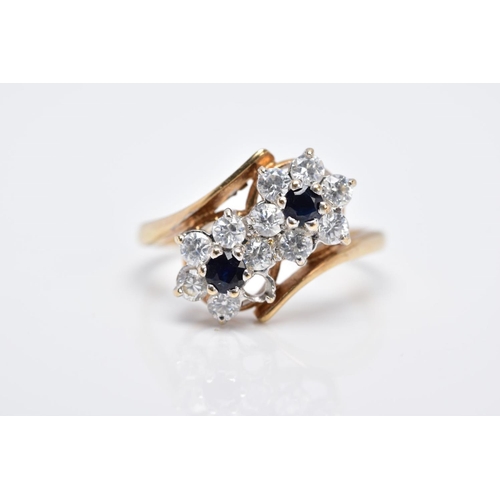 84 - A 9CT GOLD SAPPHIRE AND CUBIC ZIRCONIA DOUBLE CLUSTER RING, designed with two asymmetrical clusters,... 