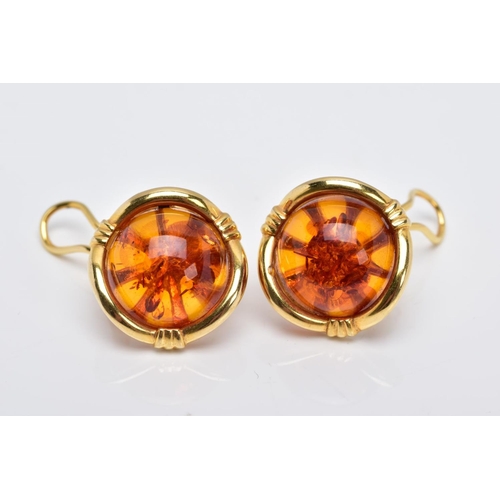 87 - A PAIR OF YELLOW METAL, AMBER CABOCHON EARRINGS, each designed with a circular cabochon amber within... 