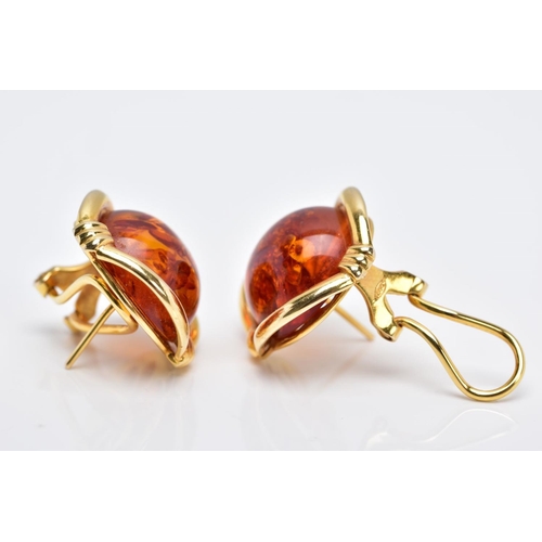 87 - A PAIR OF YELLOW METAL, AMBER CABOCHON EARRINGS, each designed with a circular cabochon amber within... 