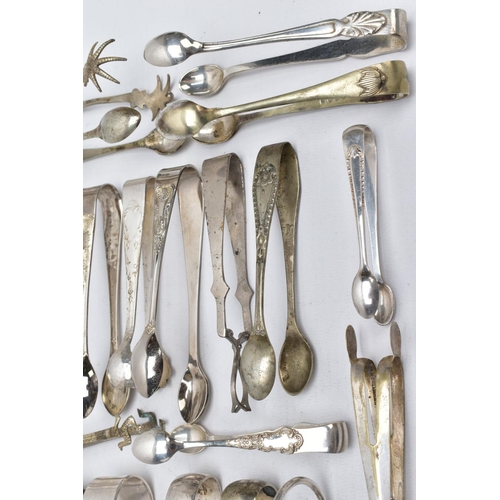 9 - A PAIR OF SILVER SUGAR TONGS AND TWENTY ONE OTHERS, to include a pair of George III bright cut sugar... 