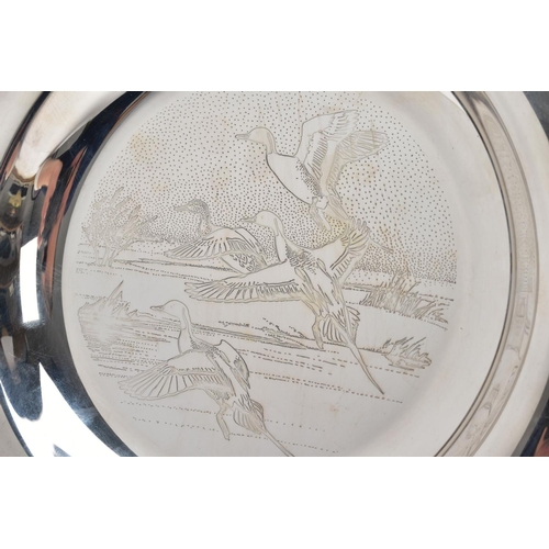 98 - A SILVER DISH, engraved ducks in mid flight scene to the centre of the dish, plain polished rim, hal... 