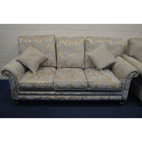 1365 - AN UPHOLSTERED TWO PIECE LOUNGE SUITE, on turned front legs, comprising a gold floral upholstered th... 