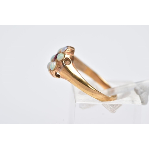 12 - A YELLOW METAL OPAL CLUSTER RING, designed with a central circular cut red stone assessed as paste, ... 