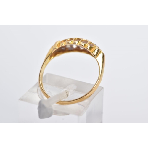 13 - AN EARLY 20TH CENTURY 18CT GOLD BOAT RING, designed with three graduated, circular cut rubies inters... 