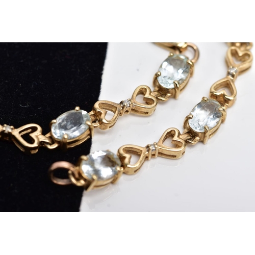19 - A YELLOW METAL GEM SET LINE BRACELET, designed with nine claw set oval cut colourless stones, assess... 