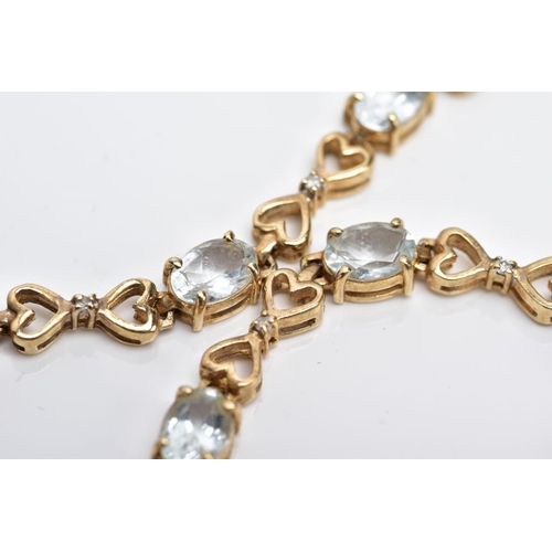 19 - A YELLOW METAL GEM SET LINE BRACELET, designed with nine claw set oval cut colourless stones, assess... 
