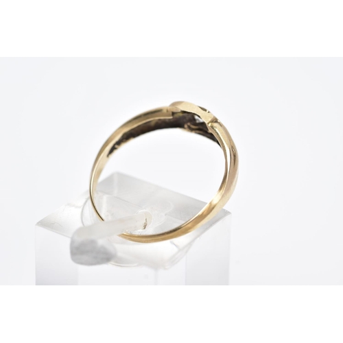 22 - A YELLOW METAL SINGLE STONE RING, designed with a central collet mounted circular cut colourless sto... 