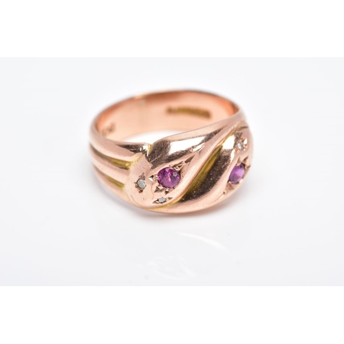 24 - AN EARLY TWENTIETH CENTURY 9CT ROSE GOLD DOUBLE SNAKE HEAD RING, set with diamonds, a ruby and an am... 