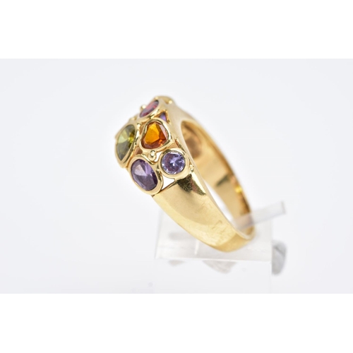 42 - A YELLOW METAL RING, a wide band set with eight various cut coloured stones, assessed as orange sapp... 