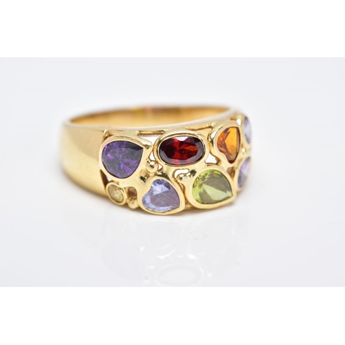 42 - A YELLOW METAL RING, a wide band set with eight various cut coloured stones, assessed as orange sapp... 