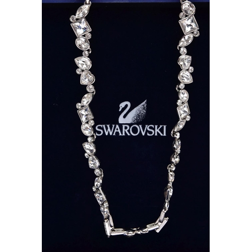 47 - A WHITE METAL SWAROVSKI CRYSTAL NECKLACE, of an articulated design set with various cut colourless c... 