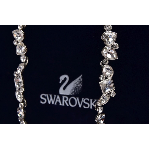 47 - A WHITE METAL SWAROVSKI CRYSTAL NECKLACE, of an articulated design set with various cut colourless c... 