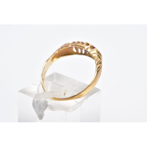 9 - AN EARLY 20TH CENTURY 18CT GOLD BOAT RING, designed with a central oval cut ruby interspaced with si... 