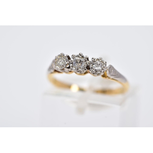 10 - A YELLOW METAL THREE STONE DIAMOND RING, designed with three illusion set diamonds, two old cut and ... 