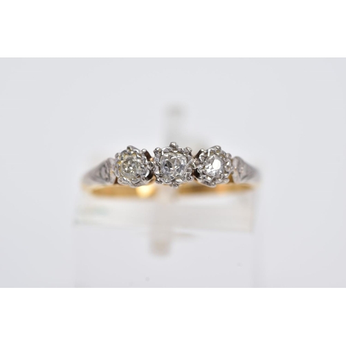 10 - A YELLOW METAL THREE STONE DIAMOND RING, designed with three illusion set diamonds, two old cut and ... 