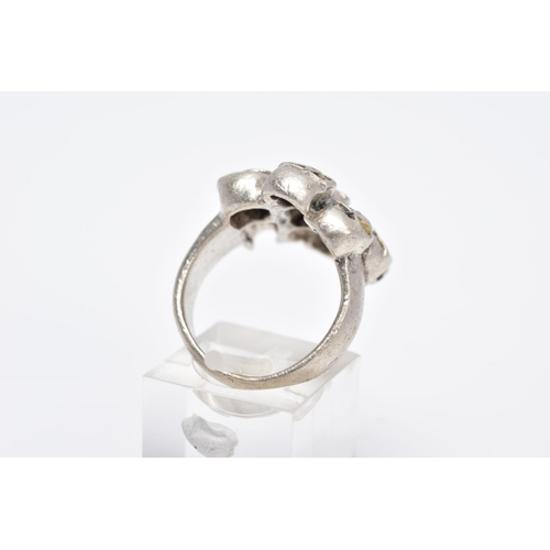 108 - A GENTS WHITE METAL SKULL RING, designed with seven pierced skulls, stamped '925', ring size O, appr... 